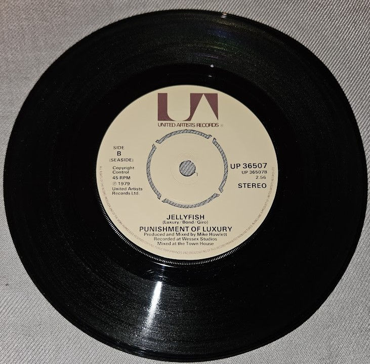Miniature : Punishment Of Luxury - Engine Of Excess / Jellyfish (7") (United Artists Records