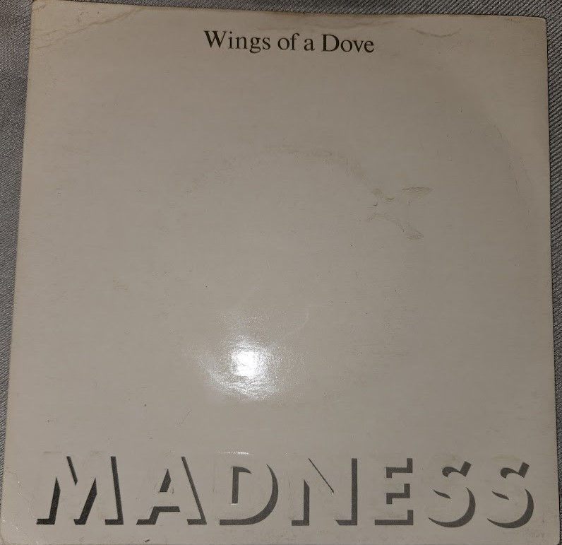 Madness - Wings Of A Dove (7", Single) (Stiff Records)