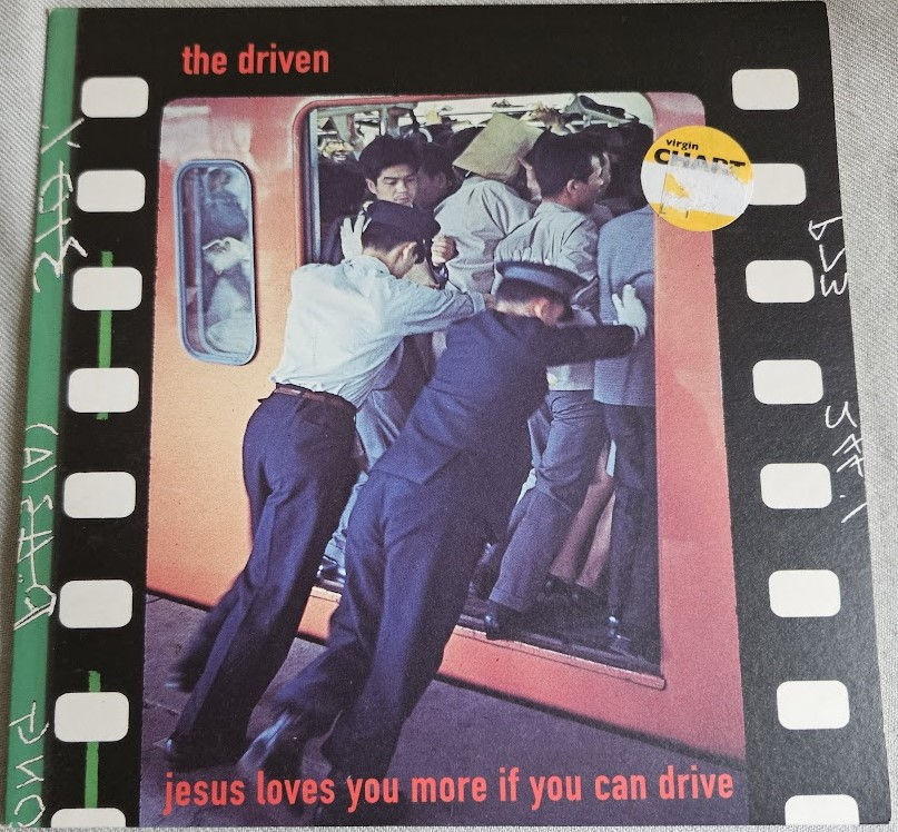 The Driven - Jesus Loves You More If You Can Drive (7", Red) (Polydor)