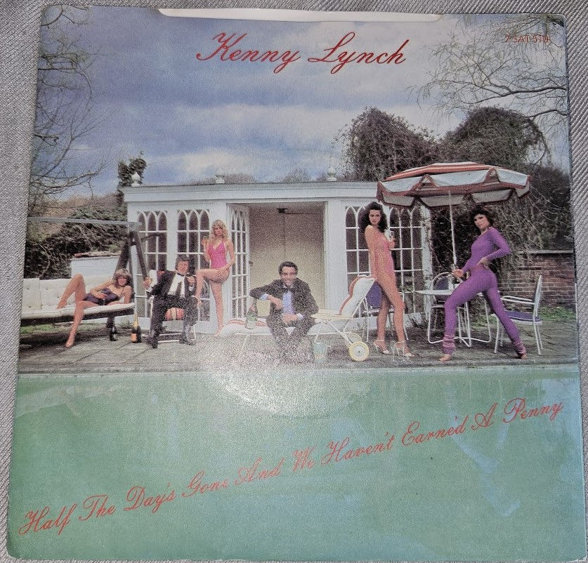 Miniatyrbild: Kenny Lynch - Half The Day's Gone And We Haven't Earne'd A Penny (7") (Satril)