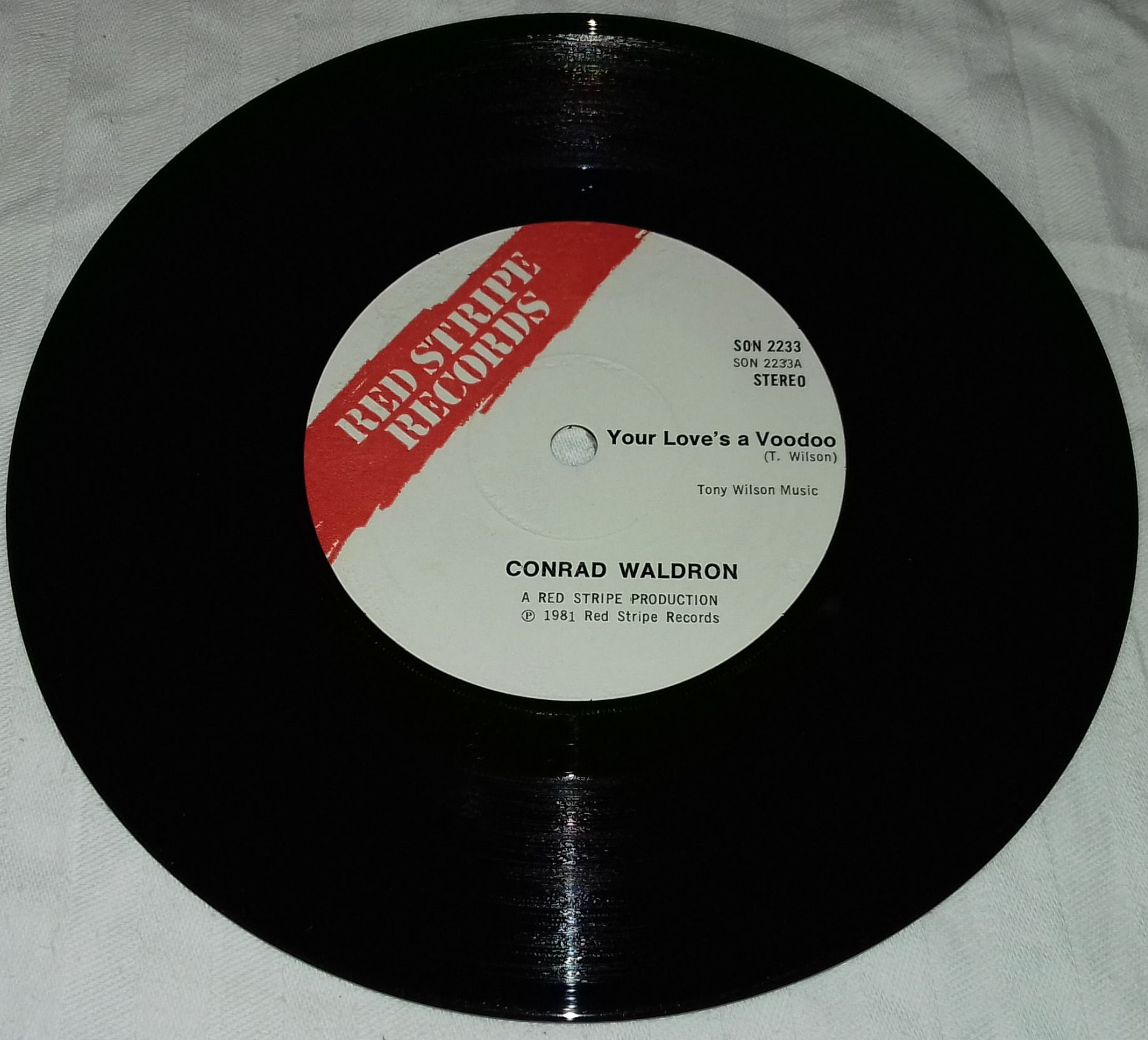 Conrad Waldron / The Red Stripe Band - Your Love's A Voodoo / The Heat Is O