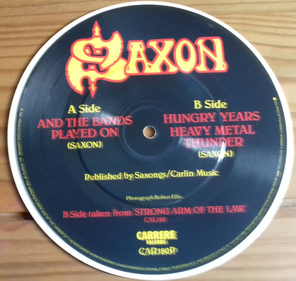 Thumbnail: Saxon - And The Bands Played On (7", Single, Pic, Whi) (Carrere)