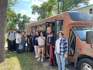 Youth group standing outside bus