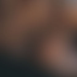 Parent and child reading a book in a cozy room