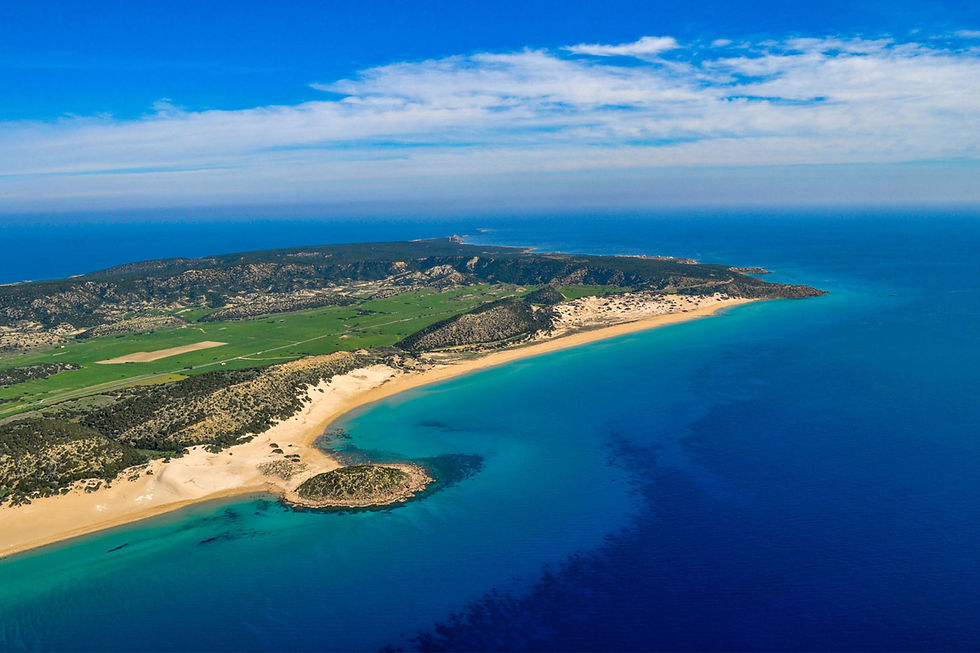 Golden Beach in Karpaz, with its expansive sandy shores and vibrant turquoise waters, offers a breathtaking view under a clear blue sky.