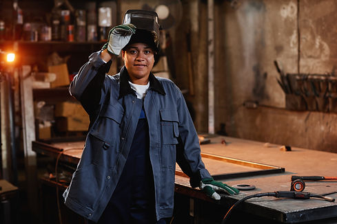 smiling-female-welder-in-workshop-2023-11-27-05-19-08-utc.jpg
