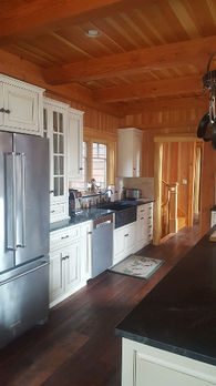 Kitchen white cabinets, stainless appliances, wood ceiling