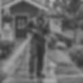 a professional photoshoot of a black man in jumpsuit uniform, pressure power washing a sid