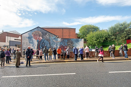 Large-scale mural titled “Dreams Never End” painted by Hayley Garner (AYLO) in Rochdale as part of Common Walls Festival. The mural features a realistic female portrait surrounded by flowing dream-like imagery, layered textures, and soft atmospheric lighting, exploring themes of hope, imagination, resilience, and personal growth through contemporary street art.