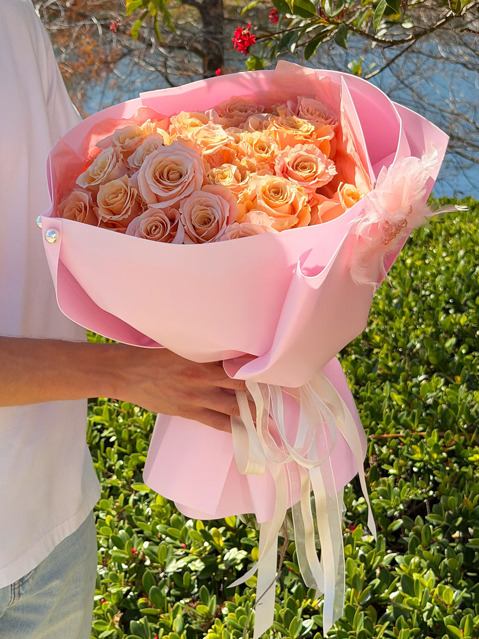 Luxury bouquet of 25 peach roses wrapped in blush pink paper in Naples Florida