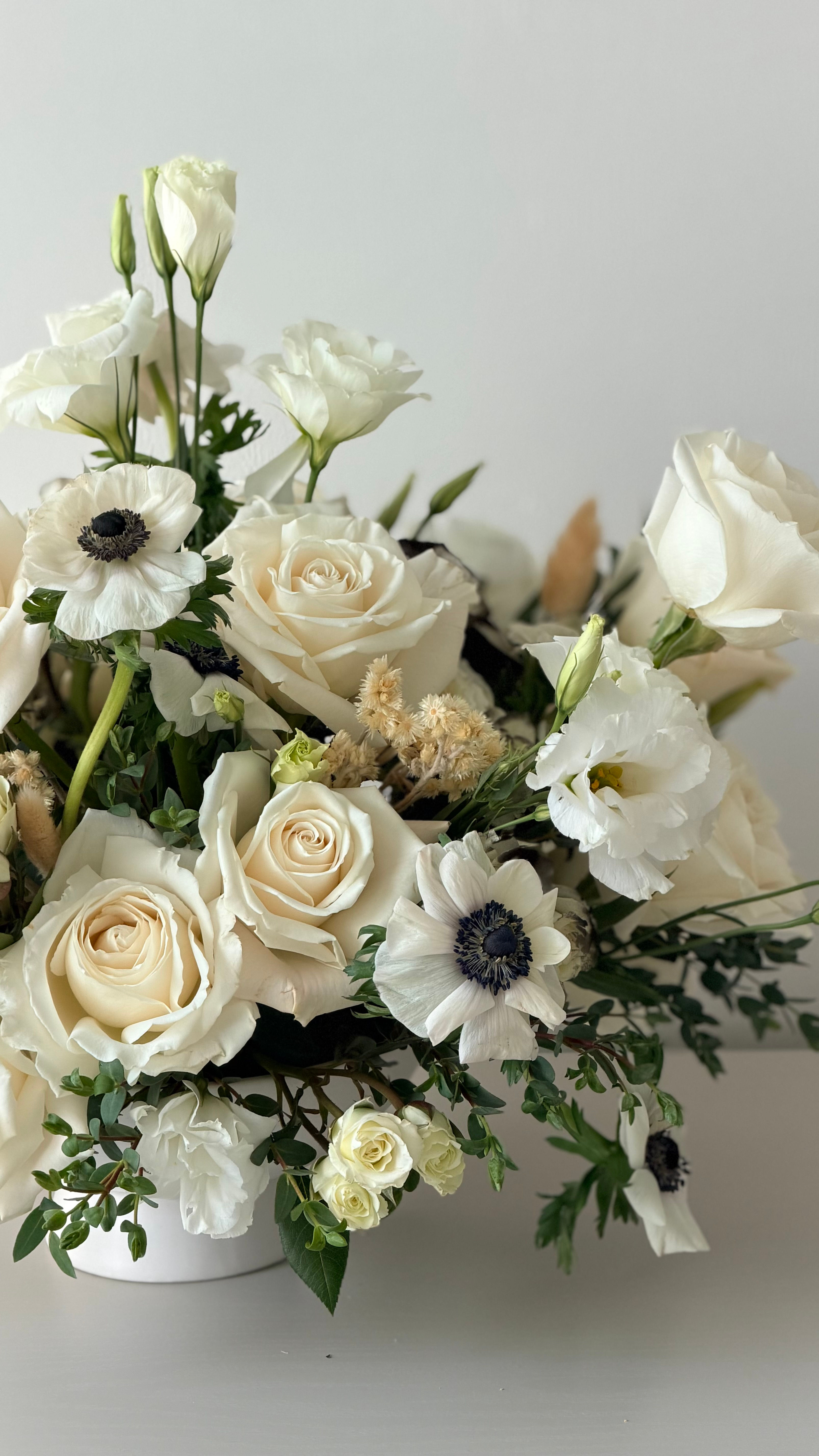 Luxury white flower arrangement with roses, anemones and lisianthus for flower delivery in Naples, Florida.