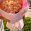 Thumbnail: Luxury bouquet of 25 peach roses wrapped in blush pink paper in Naples Florida