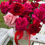 Thumbnail: Red and pink rose bouquet in a floral hatbox with red satin ribbon.