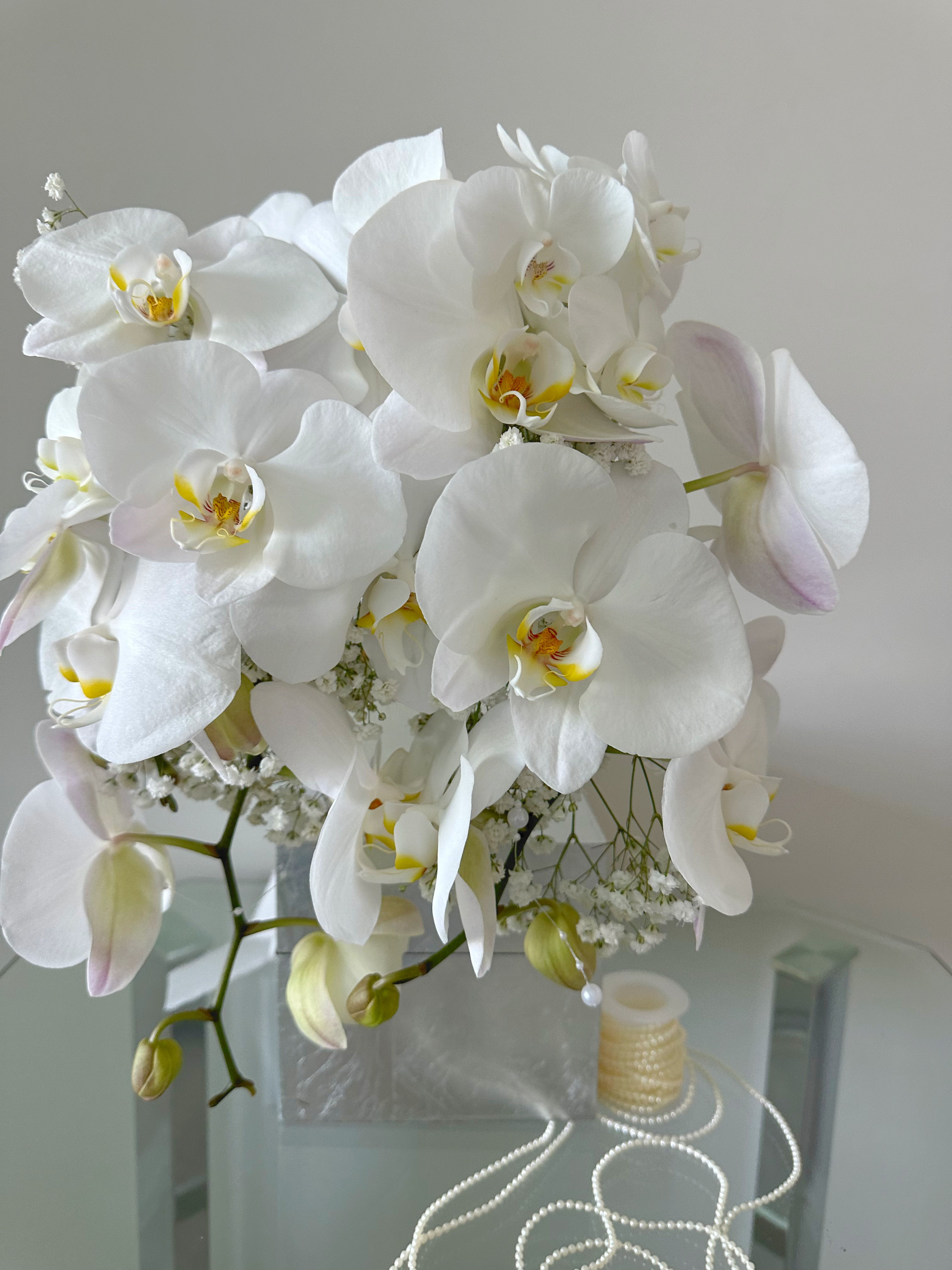 White orchid bouquet with baby’s breath