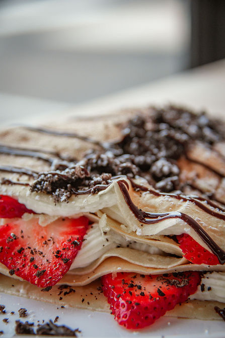 Close-up of the Strawberry Oreo crepe with fresh strawberries, cream, and crushed Oreo from First Round Boba & Crepes in Salem, Oregon.