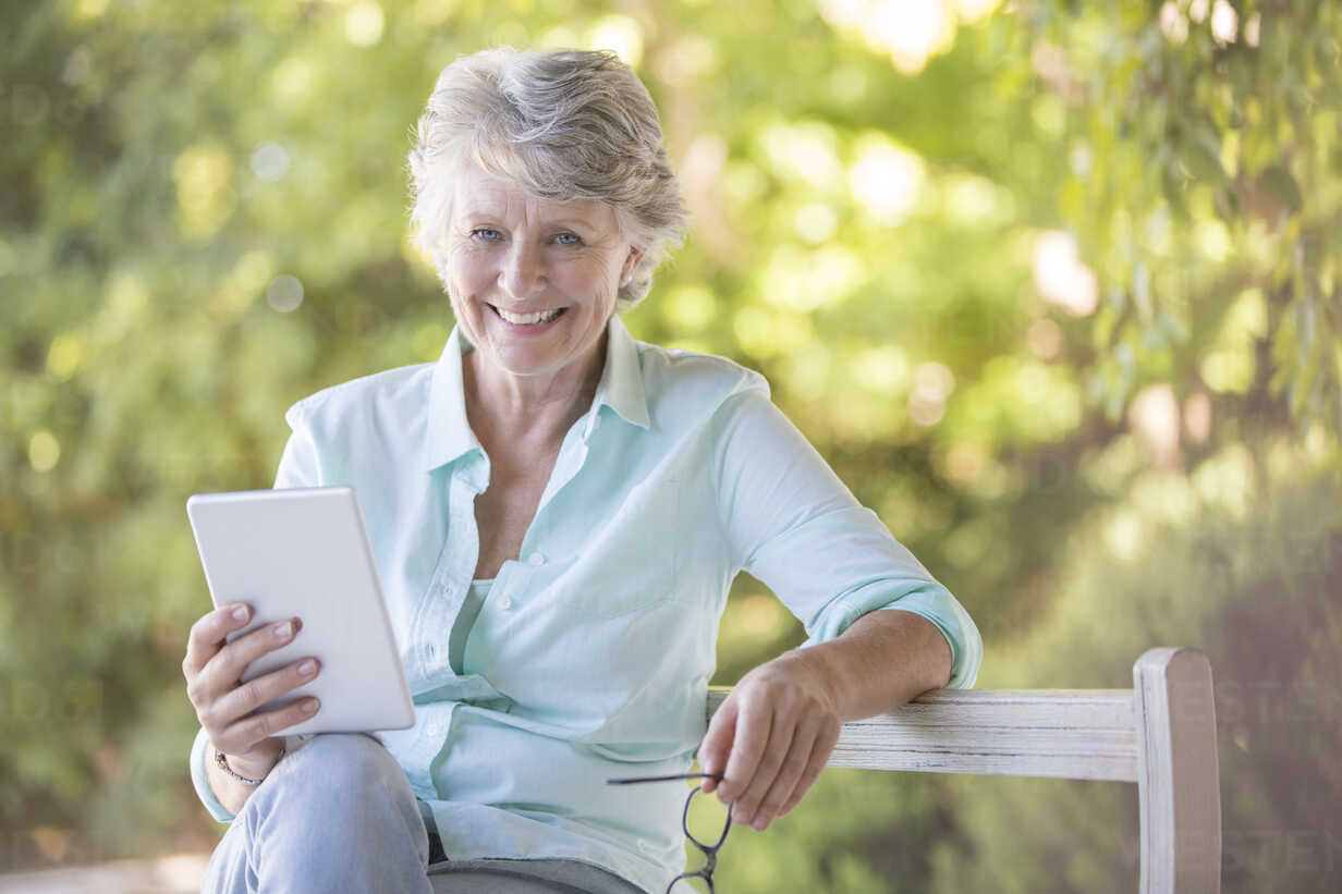 older-woman-using-digital-tablet-outdoors-CAIF16790.jpg