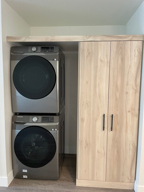 High efficiency stacked washer and dryer and custom built pantry