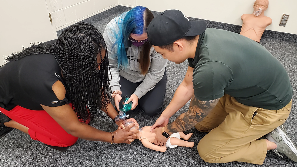 3 students performing cpr and ventilation with a BVM on a infant