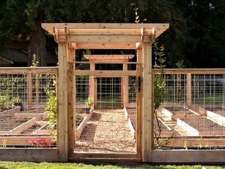 Craftsman style pergola at the entrance of hog fence wire fence garden enclosure