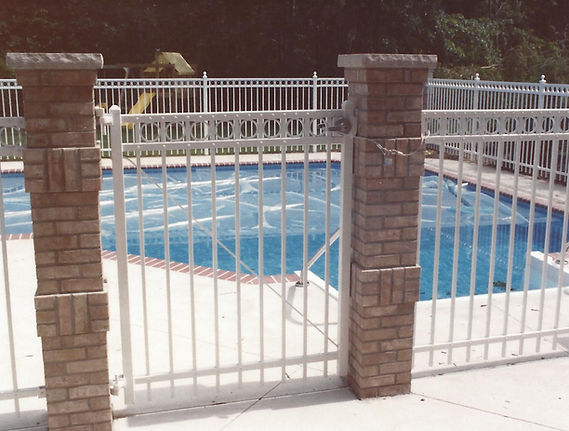eye level view of ornamental aluminum pool gate in the gloss white color. Installed by Elyria Fence