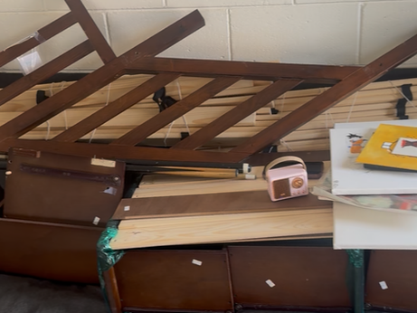 Junk removal crew carrying out old furniture such as a couch and dresser from a home for disposal and recycling.