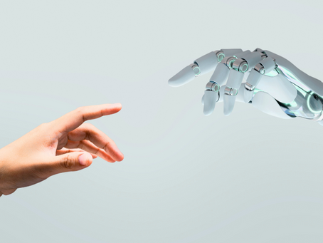 Human hand and robot hand pointing at eachother