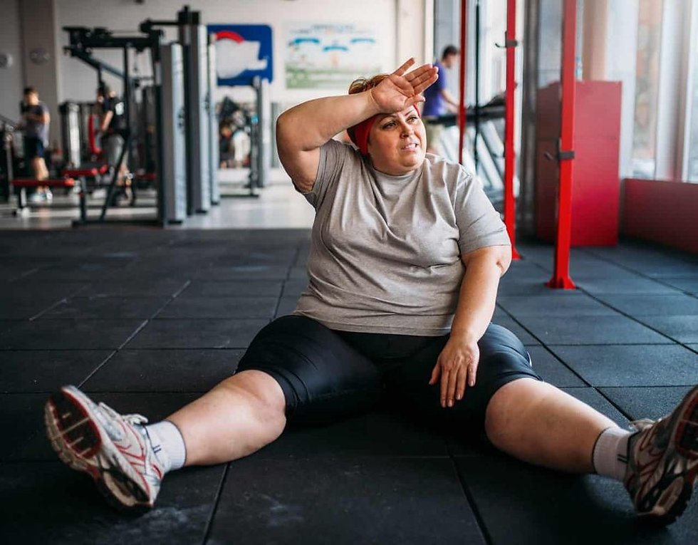 a woman in the gym sitting on the floor