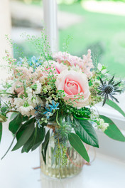Beautiful Bridal flowers in pinks and blues sitting in a vase