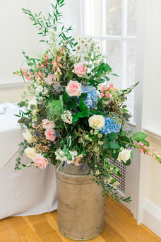 Milk churn of rich blue and pink flowers