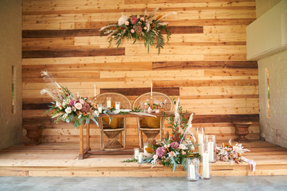 Sweetheart table in boho style with apricots, rust, blush and brown colour pallet of flowers at Marshwood Manor.