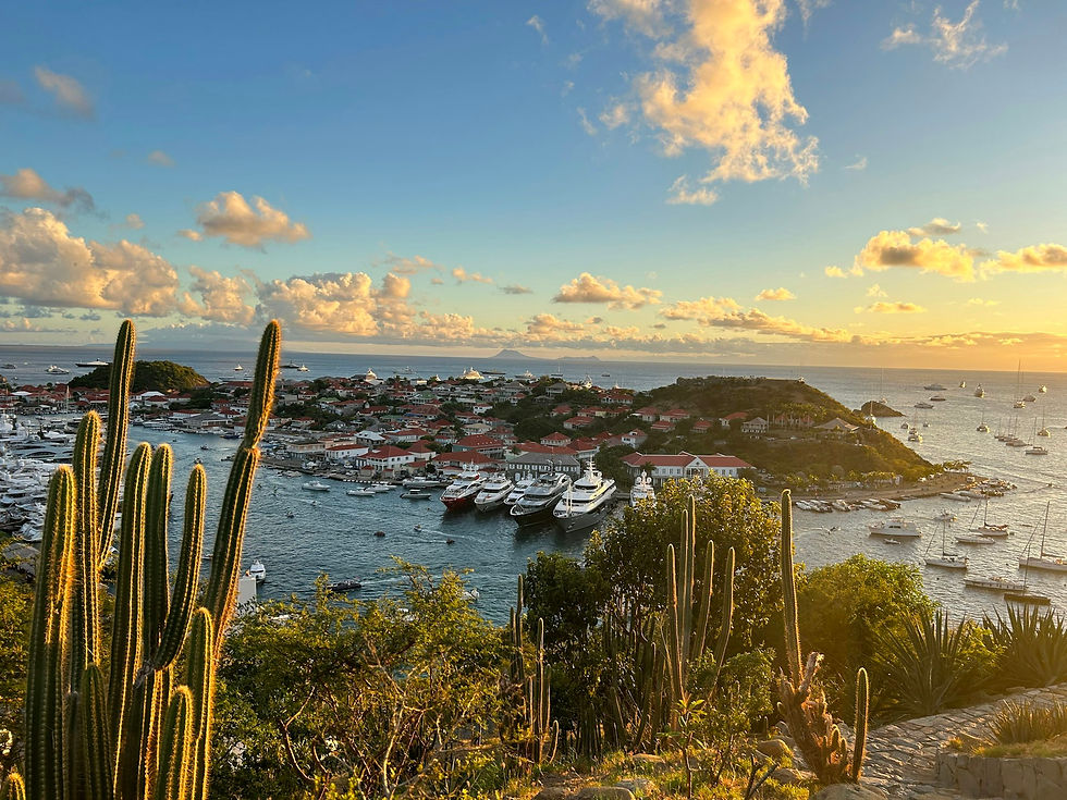 Sunset over Gustavia harbor in St. Barts, filled with yachts during the holiday season