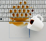 Coffee spilled on keyboard close up shot