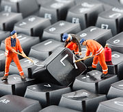 Small figurines of workers repairing com
