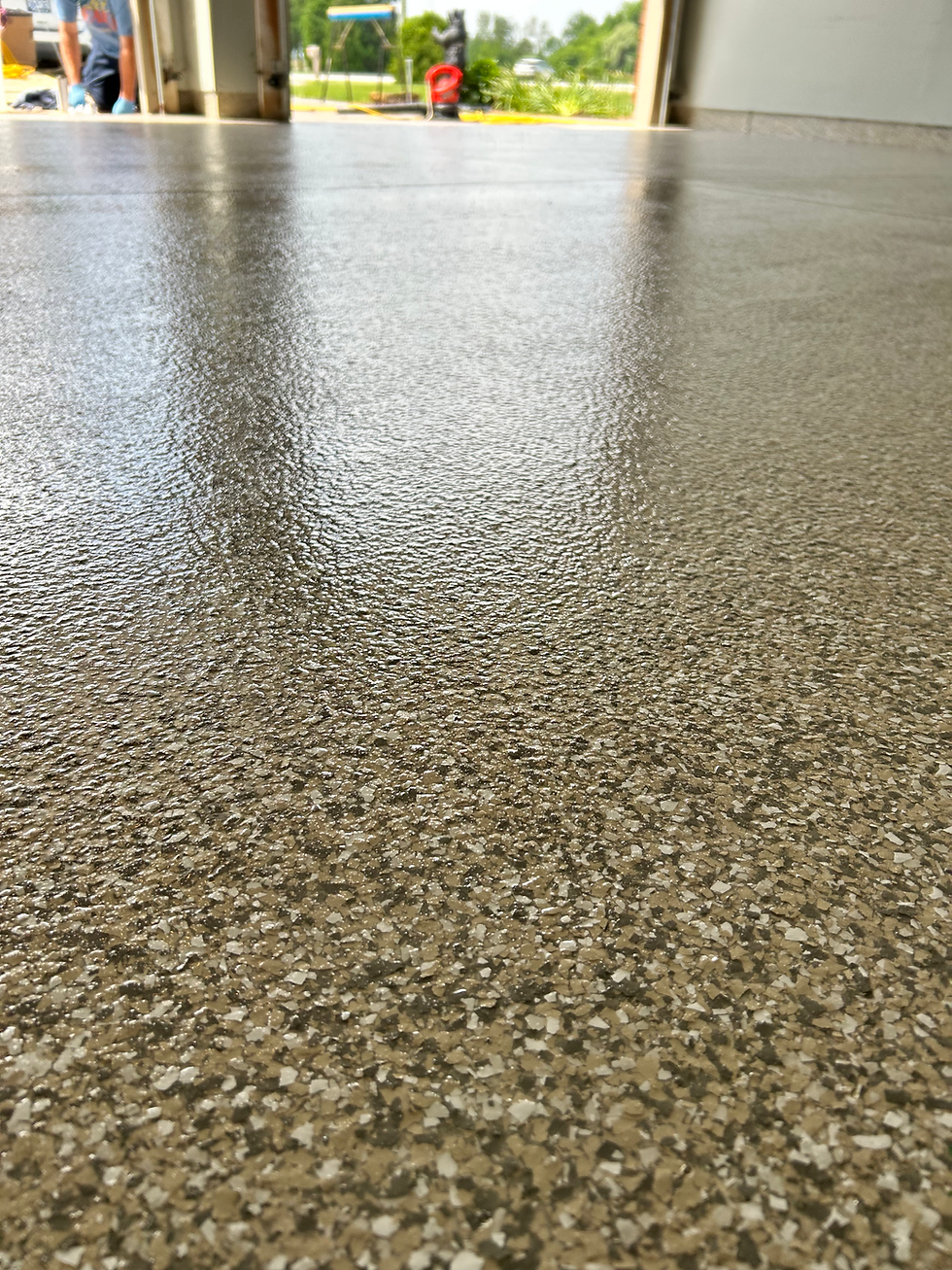 Close-up view of shiny epoxy floor with decorative flakes