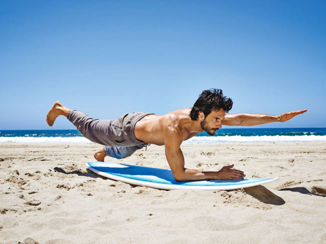 a surfer practicing yoga