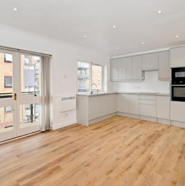 Stunning Modern Open Plan Kitchen Refurbishment with sleek wooden floors,  leading into spacious living room done by Collective Projects London, CPL