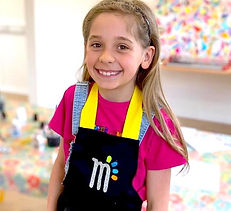Smiling girl ready to get creative at Magpie Makes art studio