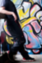 Side view of Jake wearing the black adapted cargo trousers