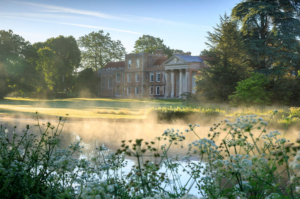 View of the north front across the lake in early morning light at the Vyne, Hampshire