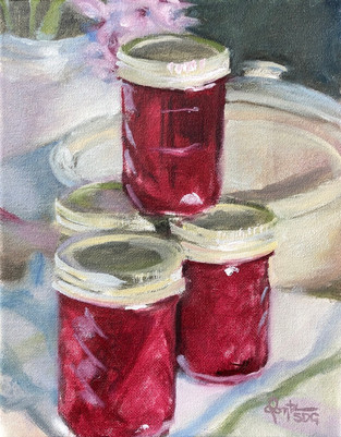 A studio still life featuring stacked jars of burgundy jam with glistening pale-gold lids sitting on a pastel plaid tea towel in front of an ivory ceramic pot with its lid askew to the rear