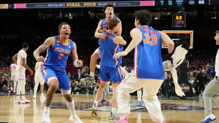 Florida Gators players celebrate their exhilarating victory with exuberant jumps and cheers on the court after a triumphant win.