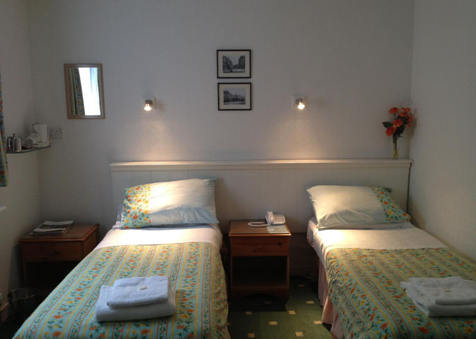 Two single beds in a large twin room