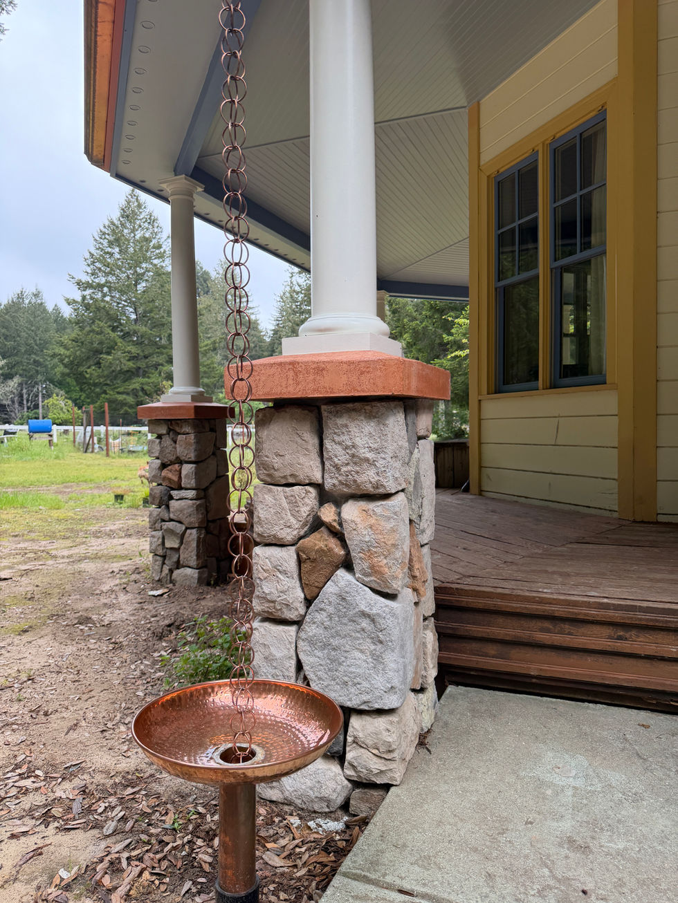 Rain chain, porch roof and deck add on to match existing Queen Anne Victorian style home.