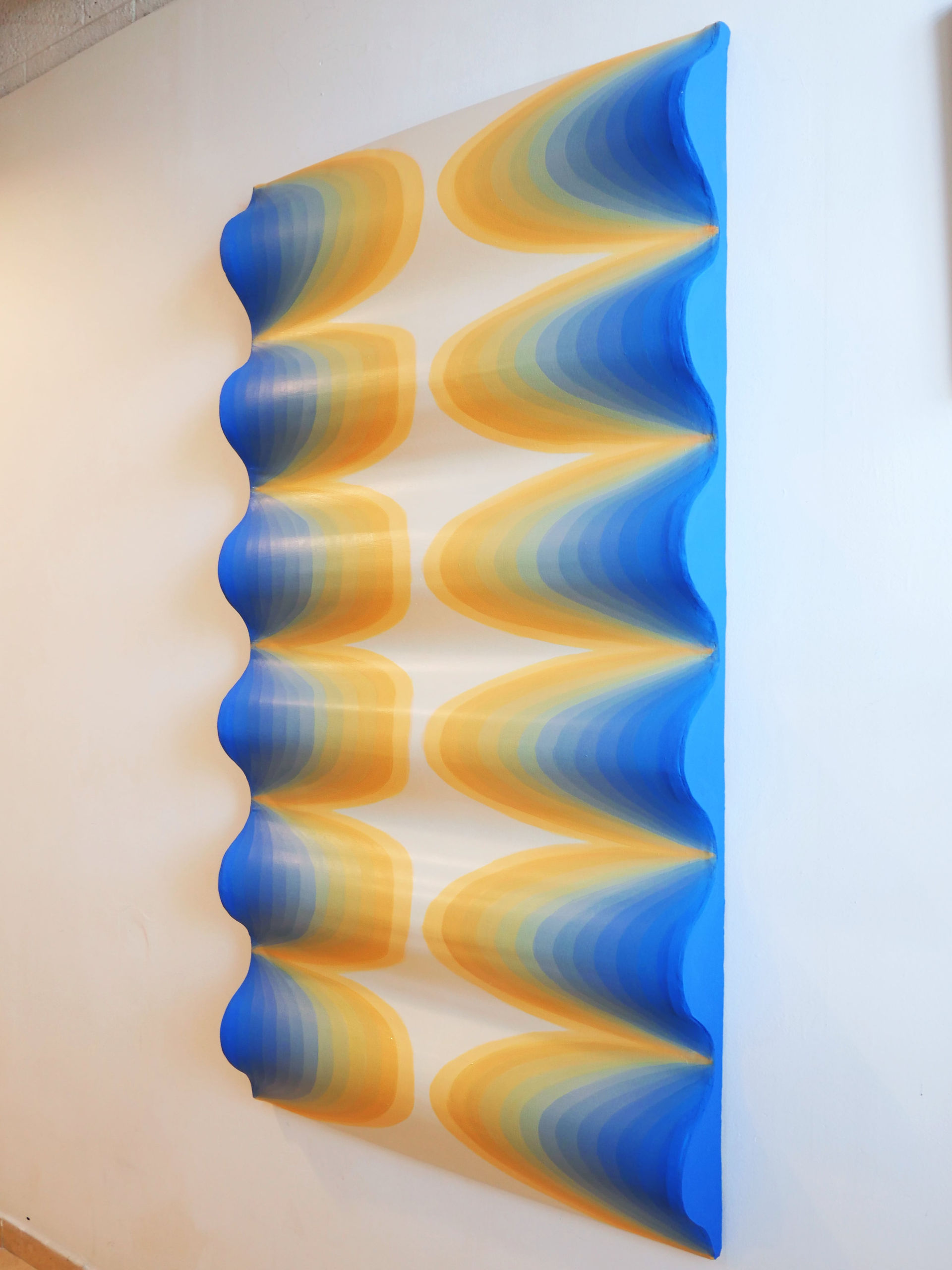 a large shaped canvas exploring light waves with a vibrant color gradient from light orange to blue by geometric artist, jessica moritz