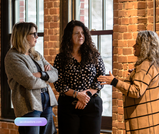 Attendees networking and discussing my.SOLIS platform at launch event in Saint John