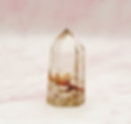 Clear Quartz Point with internal inclusions and imperfections.