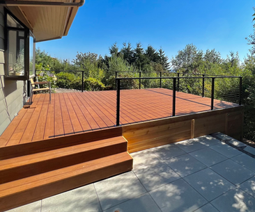 Bamboo deck with concealed fasteners and modern metal post cable railing, showcasing modern design by Masters Construction for a contemporary outdoor space.