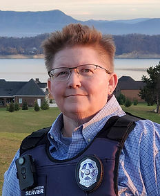 Chris Wilkinson, our founder in bulletproof vest with badge