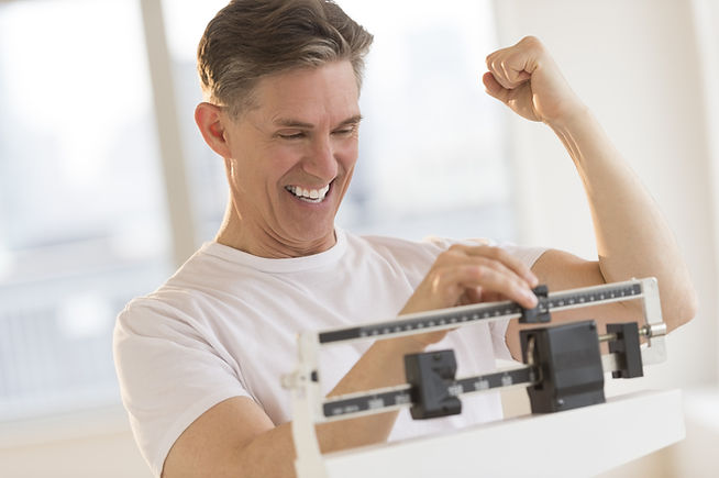 Excited mature man clenching fist while