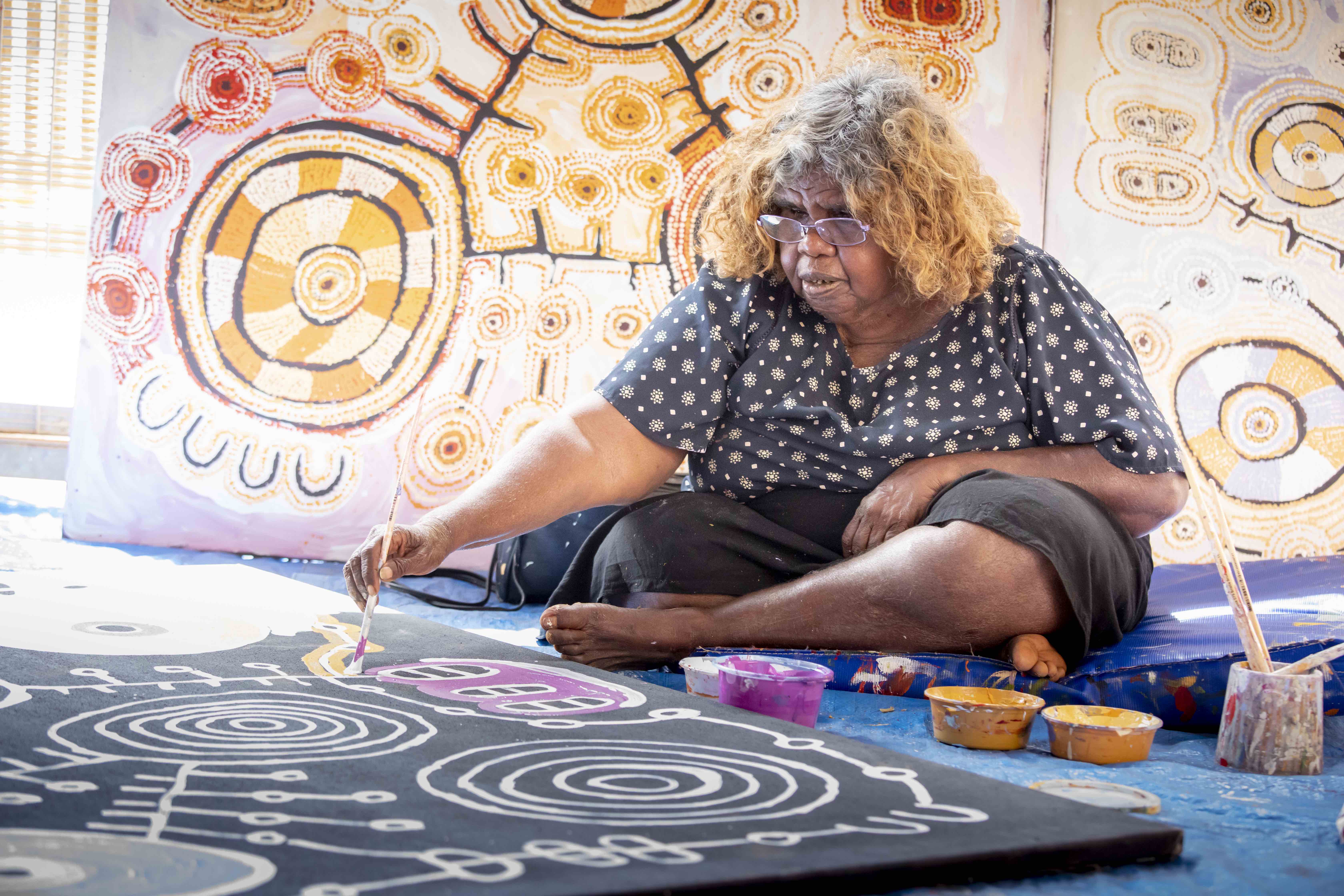 Tuppy Ngintja Goodwin working in the Mimili Maku Arts studio, photo: Meg Hansen